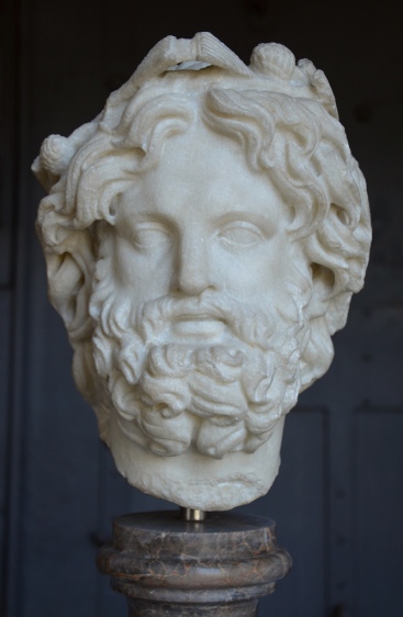 Head of Silvanus crowned with pine.